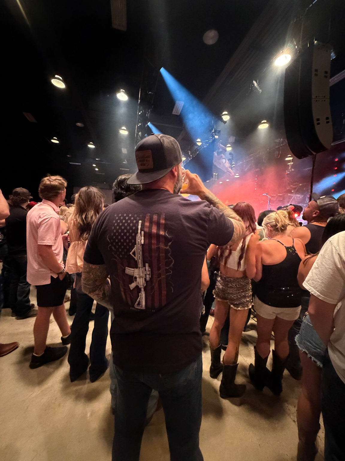 Liberty Standard Tee worn at a concert, showing the rifle and American flag back graphic.